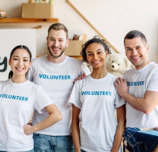 five-young-multicultural-volunteers-standing-together-smiling-and-looking-at-camera-e1657642113794.jpg